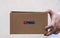 Deliveryman holding eMAG cardboard box isolated on blurred background in Bucharest, Romania, 2020