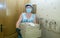 A deliverywoman. A middle-aged woman brought pizza home to a customer. The deliveryman`s work in the conditions of coronavirus