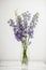 Delphinium Flower, lilac, purple flower in a vase, vertical, side view