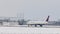 Delta Airlines taking off from Munich Airport, snow