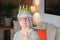 Delusional senior lady wearing a crown