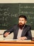 Demanding teacher. Get out of class. Teacher strict serious bearded man chalkboard background. Teacher looks threatening