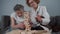 Dementia therapy. Doctor and dog play an educational table game with an elderly patient in nursing home. Caregiver, pet