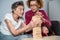 Dementia therapy. Social worker and dog plays an educational board game with senor patient at nursing home. Jenga game. Caregiver