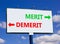 Demerit or merit symbol. Concept word Demerit or Merit on beautiful billboard with two arrows. Beautiful blue sky with clouds