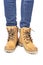 demi-season, women`s shoes, yellow, on the feet in jeans, white background, laces