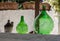 Demijohn wine bottles at cafe in Trulli village in Alberobello, Italy