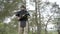 Demining. Sapper carefully carries an anti-tank warhead in his hands in forest and looking forward