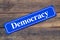 Democracy street sign on wooden background