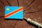 Democratic Republic of the Congo flag on a stump with syringe injecting money