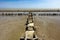 A demolished concrete trail on a pillars at the end of the way with horizon of the sea