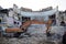 Demolished old soviet union building remains inside with bulldozer