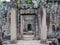 Demolished stone rock door frame at Preah Khan temple Angkor Wat complex, Siem Reap Cambodia. A popular tourist attraction nestled