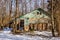 Demolished wooden structure in a forest area in winter