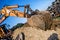 Demolishing operations at industrial construction site. worker using bulldozer wrecking