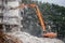Demolition of building with excavator-destroyer for high-altitude work