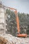 Demolition of building with excavator-destroyer for high-altitude work