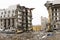 Demolition of concrete apartment building with hydraulic excavator