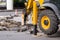 Demolition hammer excavator with wheel and bearing closeup