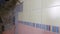 Demolition of old tiles with jackhammer. Renovation of old walls in the bathroom or kitchen