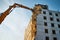 Demolition of residential building with crawler excavator