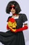 Demonic brunette Girl in red gloves holding gold skull. Role-playing games, halloween, party shop trendy accessories concept