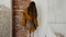 Demonstration of clothes, girl changes her poses in fashionable clothes stands near brick wall
