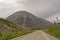 Demster Highway leading to a distinctive eroded mountain