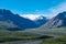 Denali National Park from Polychrome Pass on a sunny day, storm clouds roll in across a peak