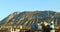 Denia Spain. View of Mount Montgo and the city from afar, beautiful colorful buildings, sunset, blue sky