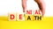 Denial death symbol. Concept words Denial Death on wooden block. Beautiful yellow table white background. Businessman hand.