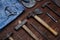 Denim jeans and carpenter worn tools kit over wooden background