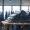 Denim jeans stack showcased on wooden table in store setting