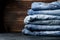 Denim. Lots of blue jeans on wooden background