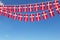 Denmark flag festive bunting hanging against a blue sky. 3D Render