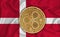 Denmark flag, ripple gold coin on flag background. The concept of blockchain, bitcoin, currency decentralization in the country.