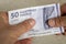 Denmark Money, Lowest 50 danish kroner banknote Held in hands, Financial and business concept