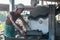 Denpasar, Bali, Indonesia, August 2020. A man cuts a black volcanic stone with a water jet cutting machine, Bali, Indonesia