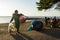 DENPASAR/BALI-JUL 22 2020: a janitor is cleaning trash around sanur beach which is full of visitors. Indonesia has started to open