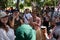 DENPASAR/BALI-JUNE 15 2019: Papuan dancers are chatting with foreign tourists from Europe before the show at the opening of the