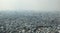 Dense air pollution and smog over Saigon, Vietnam Ho chi Minh City. Overpopulated city, urban sprawl. Aerial view.