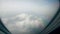 Dense clouds are seen from and airplane window