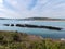 Dense coastal bushes. View of Clonakilty Bay. Sea rocks. A picturesque place in northern Europe, rock formation near body of water