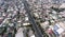 A dense and crowded section of Metro Manila separated by the Skyway, an elevated highway in the metropolis