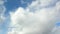 Dense cumulus clouds against the clear blue sky. Nice weather, time-lapse.