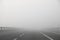 dense dangerous fog on the highway without cars