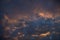 Dense dramatic painted clouds at sunset of the day against a blue sky