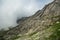 Dense fog envelops the top of the mountain in Ergaki