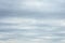 Dense gray thunderstorm cumulus wavy clouds in the whole frame. Gloomy rainy Sky background to overlay on your photos