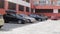 Dense parking in the courtyard of a high-rise building. Lots of cars in the parking lot. Modern residential complex. Crowded, few